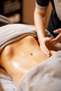 Masseuse performs professional abdominal massage for a woman