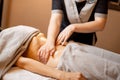 Masseuse performs professional abdominal massage for a woman