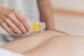 Masseuse pouring masage oil on the body. Royalty Free Stock Photo