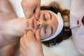 masseuse with working hands massages the face of a female client in a spa salon. Royalty Free Stock Photo