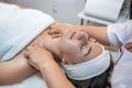 masseuse with working hands massages the face of a female client in a spa salon. Royalty Free Stock Photo