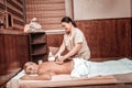 Masseuse working with herbal bags in her hands.