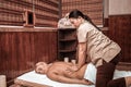 Masseuse working with low back of her client.