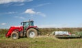 Massey Ferguson parked up in field with load on trailer