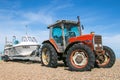 A 3085 massey ferguson pulling a speed boat on a pebble boat