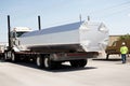 massive aluminum ingot being transported by truck