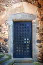 Massive antique outside wooden door of a chateau, castle with many small square windows Royalty Free Stock Photo