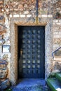 Massive antique outside wooden door of a chateau, castle with many small square windows Royalty Free Stock Photo