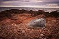 Massive boulder against the backdrop of Hoga Kusten's clapper fields and the Bothnian Sea. Royalty Free Stock Photo