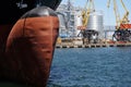 The massive bow of a large ship, with the radar dome above the surface of the water with crane, at the seaport. Royalty Free Stock Photo