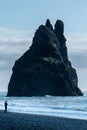 Massive cliff against the background of the sky. Black Sand Beach Reynisfjara, Iceland. Royalty Free Stock Photo