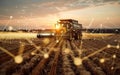 A massive combine harvester dwarfs the surrounding wheat field under a dramatic cloudy sky, showcasing the sheer scale Royalty Free Stock Photo