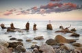 Massive concrete tetrapods form a breakwater with soft blur sea