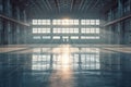 Massive empty airplane hangar with sunlight streaming through windows Royalty Free Stock Photo