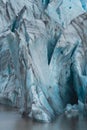 Massive glacier tongue end cracks over the lake, long shot