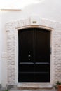 Massive historic high house wooden door entrance black dark classic big wood home gate Royalty Free Stock Photo