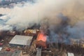 Massive large blaze fire in the city, aerial drone top view brick factory building on fire, hell major fire explosion flame blast