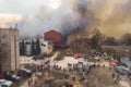 Massive large blaze fire in the city, aerial drone top view brick factory building on fire, hell major fire explosion flame blast