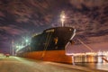 Moored oil tanker at night with a dramatic cloudy sky, Port of Antwerp, Belgium. Royalty Free Stock Photo