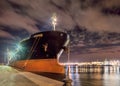 Moored oil tanker at night with a dramatic cloudy sky, Port of Antwerp, Belgium. Royalty Free Stock Photo