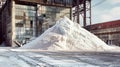 A massive pile of snow envelops the entrance of an industrial building processing potash fertilizers in a wintry scene