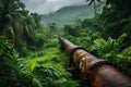 A massive pipe stands prominently amidst the lush greenery of a dense jungle, surrounded by towering trees and tangled vegetation Royalty Free Stock Photo