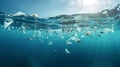 Massive plastic and other debris slowly drifts under surface of the blue ocean in the sun lights.