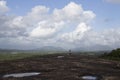 A massive rock formations and a child on the edge and dramatic sky