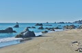 Massive rocks jutting out of the ocean during low tide.