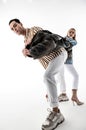 Man wearing massive sneakers posing in jacket with woman Royalty Free Stock Photo