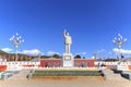Massive statue on Mao Tse Tung against blue sky in Lijiang main Square