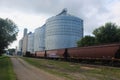 Massive Steel and Concrete Grain Elevators with Rail Cars in Front