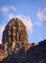 Massive stone face tower at Bayon temple, located in Angkor, Cambodia, the ancient capital city of the Khmer empire. View from the Royalty Free Stock Photo