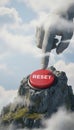 Giant stone hand pushing a large red reset button on a mountain peak against blue sky Royalty Free Stock Photo