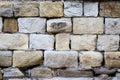 Massive a stone masonry with grey, light brown rectangular rocks. Erased adhesive mixture Royalty Free Stock Photo