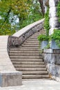 Massive stone staircase around an ancient castle in a green park. Vertical image Royalty Free Stock Photo