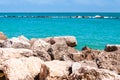 Massive stones rocks lying on the beach as a border between pebble beach Spiaggia del Frate and Adriatic sea waves and flows.