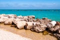 Massive stones rocks lying on the beach as a border between pebble beach Spiaggia del Frate and Adriatic sea waves and flows.