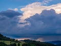 Massive storm clouds in the sky over hilly landscape Royalty Free Stock Photo