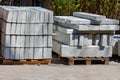 Concrete curbs are stacked against the backdrop of bright sunlight, close-up Royalty Free Stock Photo