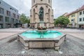 Massive tower of the town church in Balingen and the market fountain well, Germany