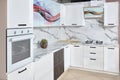 Massive white brushed oak cottage urban rustic loft style kitchen interior in wooden finish and granite stoneware with Royalty Free Stock Photo