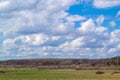 Massive white cumulus clouds in the blue sky over the forest Royalty Free Stock Photo