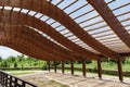 Massive wood beams roof structure with S curved shaped and covered with transparent polycarbonate sheet Royalty Free Stock Photo