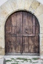 Massive wooden door with an iron lock in the architecture of Medieval Europe Royalty Free Stock Photo