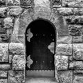 Massive wooden door in a stone wall made of large granite blocks Royalty Free Stock Photo