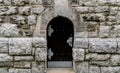 Massive wooden door in a stone wall made of large granite blocks Royalty Free Stock Photo