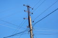 Mast electrical power line against blue sky