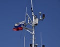 Mast of the port service ship. Devices of light signaling and communication antenna. Royalty Free Stock Photo