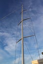 The mast and rigging of a racing yacht stands out against the clear blue sky Royalty Free Stock Photo